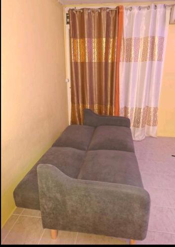 a bed sitting in a room with a window at Studio Fort-de-France in Fort-de-France