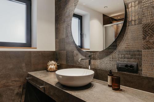 a bathroom with a bowl sink and a mirror at Dolomites Chalet Niuasi in Ortisei