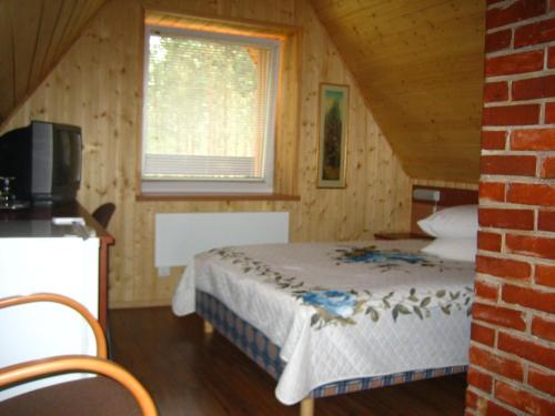 A bed or beds in a room at Holiday Complex Šilaičiai