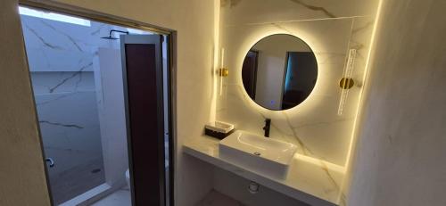 a bathroom with a sink and a mirror at Residencia G in Champotón
