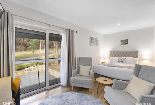 a bedroom with a bed and a large window at Merry Mary in Marysville