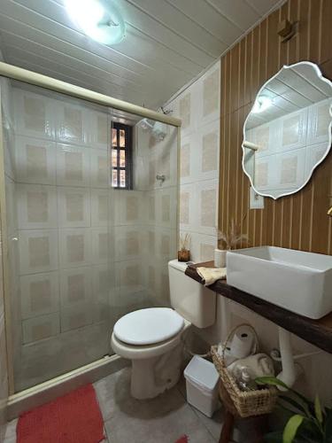a bathroom with a toilet and a shower and a sink at Recanto da barra in Ilha do Bom Jardim
