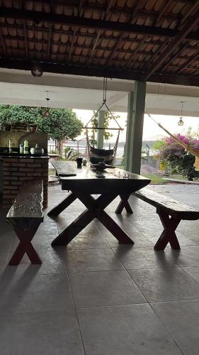a picnic table and a bench on a patio at Lagoa do Bonfim RN in Natal