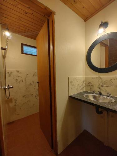 a bathroom with a sink and a mirror at Welpen Chapa in Mar del Plata
