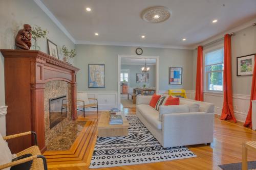 a living room with a couch and a fireplace at Brooklyn Gem 3 Blocks to Prospect Park - 3 King Beds 1 Queen, Free parking, in Brooklyn