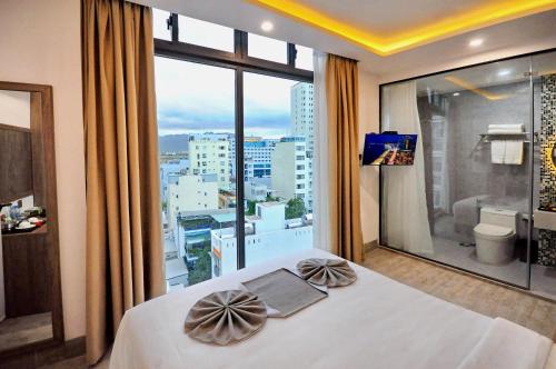 a hotel room with a bed and a large window at Violet hotel 2 in Nha Trang