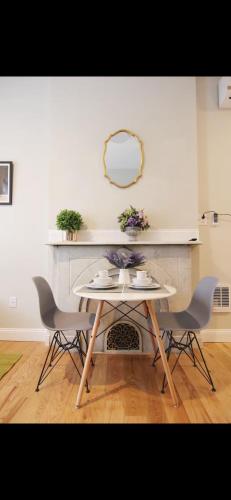 a table with two chairs and a table with a mirror at Bright Private Apartment in University City Walk to Drexel&Near UPenn in Philadelphia