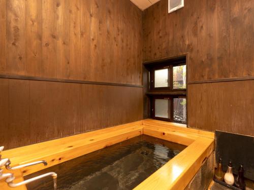a pool of water in a wooden bath room at Wa no Yado Sagiritei in Yufu