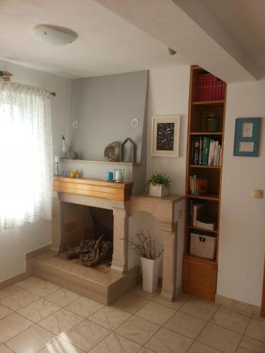 a living room with a fireplace and a book shelf at Apartment Palma in Korčula