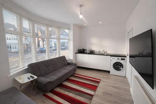 a living room with a couch and a tv at Cozy 1-Bed Flat Ideal for Short & Long Stays in Manchester