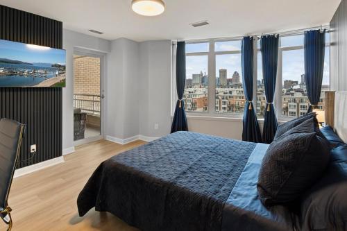 a bedroom with a bed with a view of a city at Willow Estates Harborplace in Baltimore