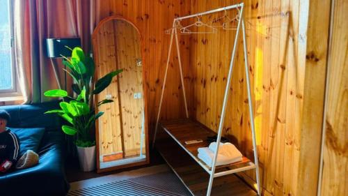a room with a wooden wall with a swing at Villa Đường Mây 2 in Tam Ðảo