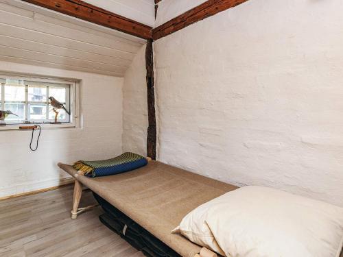 a bedroom with a bed in a room with a window at 4 person holiday home in Asaa in Aså