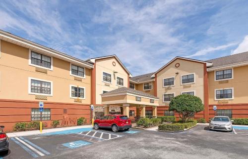 a car parked in a parking lot in front of a building at Extended Stay America Select Suites - Jacksonville - Lenoir Avenue East in Jacksonville