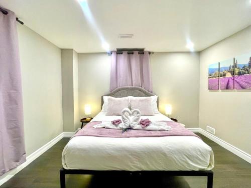 a bedroom with a bed with two towels on it at Violet Escape Modern Apt 1B 1B, Kitchen, Parking in Richmond Hill