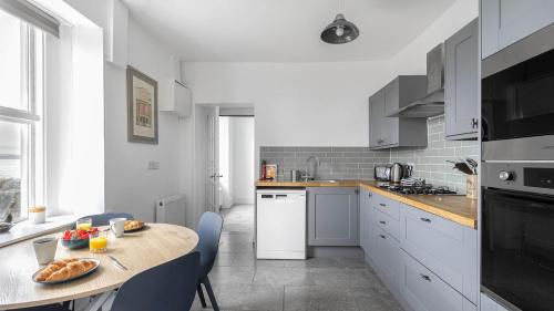 a kitchen with a table with a plate of food on it at Craigend Cottage in Rothesay