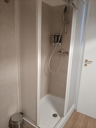 a shower with a glass door in a bathroom at JeD SWEET DREAMS in LʼAquila