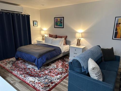 a bedroom with a bed and a blue couch at Scenic Farmhouse in Riverton