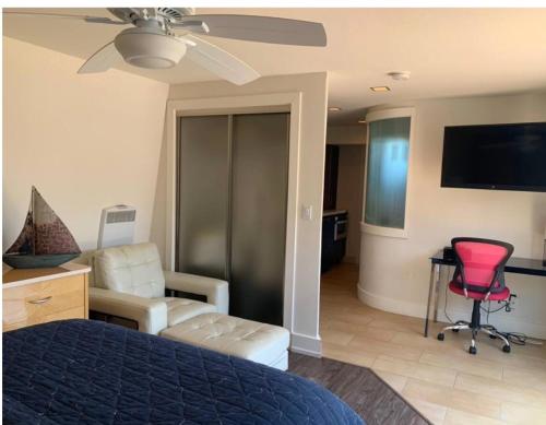 a bedroom with a bed and a desk and a chair at Bodega Bay Magical Ocean Front w/Amazing View! in Bodega Bay