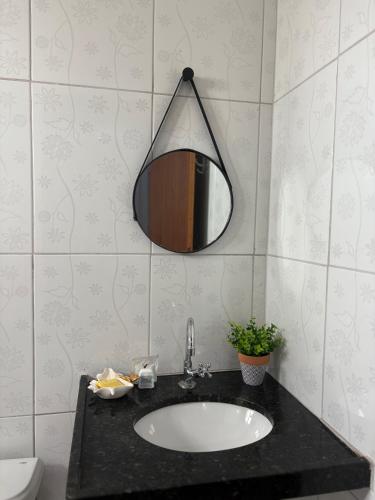 a bathroom with a sink and a mirror on the wall at Temporada AK Freitas in Parnaíba
