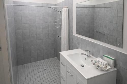 a white bathroom with a sink and a shower at Highway One Motel in Ceduna