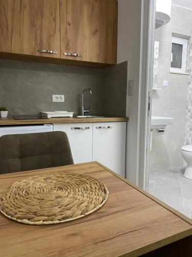 a kitchen with a table with a bowl on top of it at Vila Seawolf Apartments in Sutomore