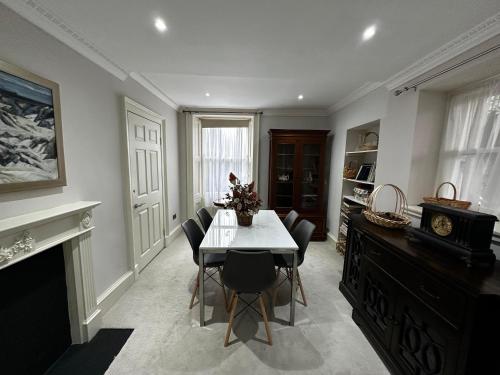 a dining room with a table and chairs at Merchiston Residence in Edinburgh
