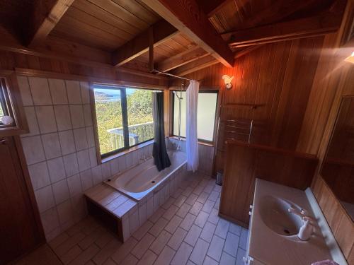 a large bathroom with two sinks and a tub at Abel Tasman guest house in Marahau