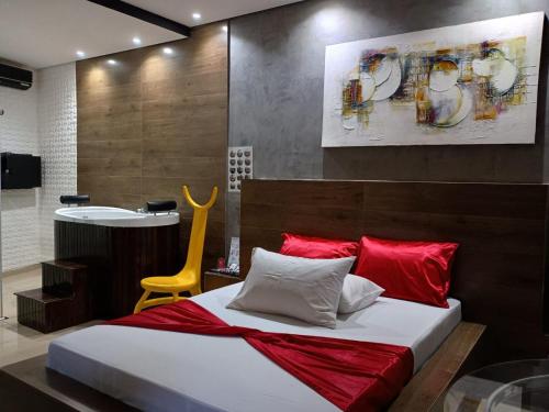 a bedroom with a large bed with red pillows at Segredos in Araras