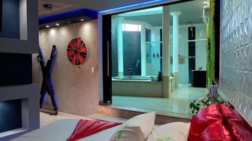 a room with a bed and a large glass window at Segredos in Araras