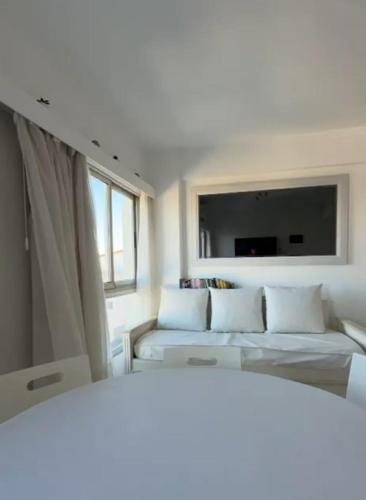 a room with two beds and a flat screen tv at CoSTA Y MAR II in Villa Gesell