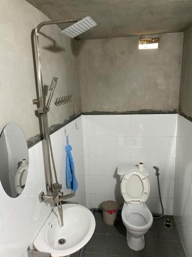 a small bathroom with a toilet and a sink at Friendly Homestay & Authentic Trekking Tours in Sapa