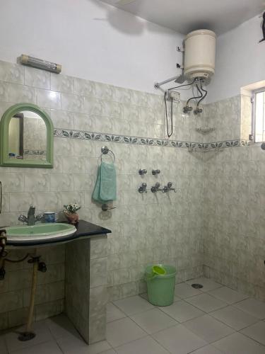 a bathroom with a sink and a shower with a mirror at Smriti- loving memories in Jaipur