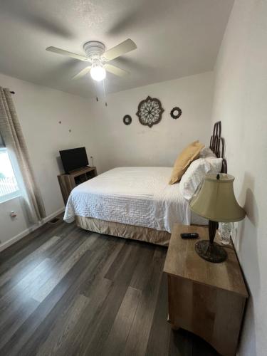 a bedroom with a bed and a ceiling fan at Near Red Mountain park in Mesa