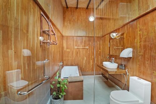a bathroom with a toilet and a sink at Lake Resort Bolgoda in Wadduwa