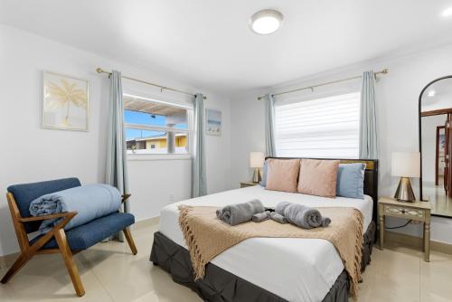 a bedroom with a large bed and a chair at Miami Retreat, Private Pool and Patio 3B in Miami