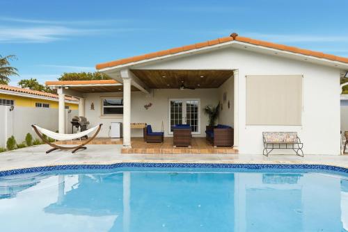 a swimming pool in front of a house at Miami Retreat, Private Pool and Patio 3B in Miami
