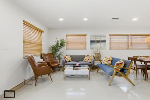 a living room with a couch and chairs and a table at Miami Retreat, Private Pool and Patio 3B in Miami
