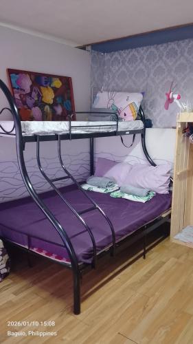 a bunk bed in a room with a purple mattress at Ingeritch Cabin Transient and Homestay in Baguio