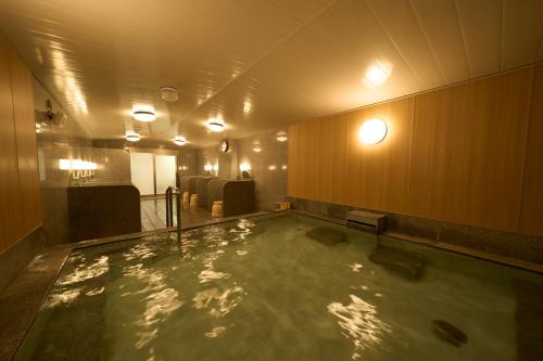 a large pool of water in a room at Hotel Hokke Club Fukuoka in Fukuoka