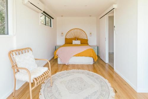 a bedroom with a bed and a chair at Franklin's Place in Belmont