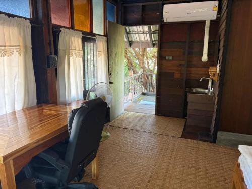 a office with a desk and a chair in a room at The Bodhi House in Chiang Mai