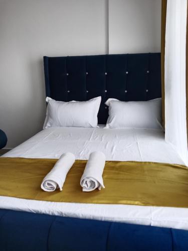 two towels on a bed with two pillows on it at Relax Crib Nairobi in Nairobi