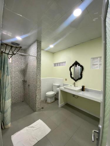 a bathroom with a toilet and a sink and a shower at Puri Pangeran Hotel in Yogyakarta