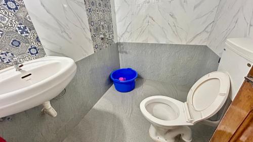 a bathroom with a white toilet and a sink at Muffys Baga Apartment in Baga