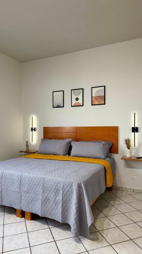 a bedroom with a large bed with three crosses on the wall at Departamento Estrella in La Paz