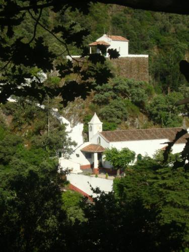 a small white church on the side of a mountain at Apartamento Artur in Lousã