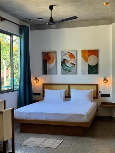 a bedroom with a bed with two pillows at Cielo Hiriketiya in Hiriketiya