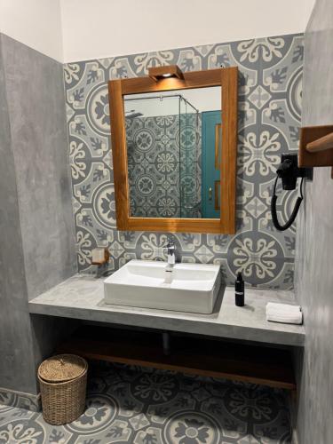 a bathroom with a sink and a mirror at Cielo Hiriketiya in Hiriketiya
