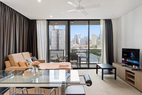 a living room with a couch and a table at Level 10 Views 2BR with Private Balcony & Parking in Brisbane